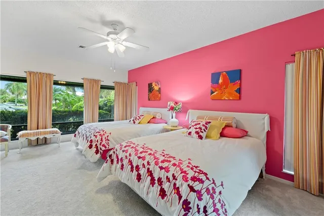 a bedroom with a bed and a large window