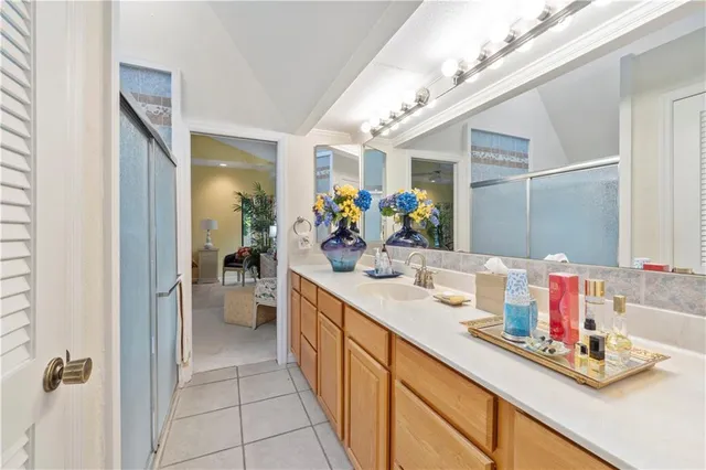 a bathroom with a double vanity sink mirror and shower