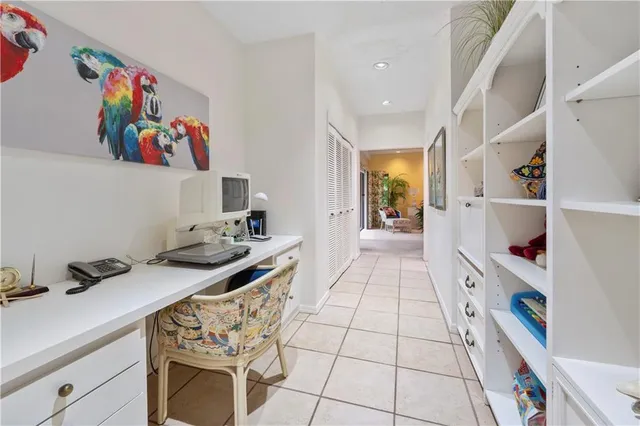 a hallway with a dining table chairs and cabinets