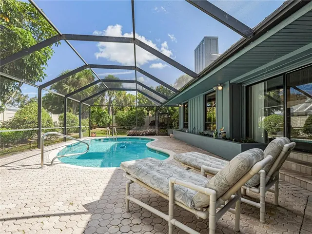 a view of a patio with a table and chairs