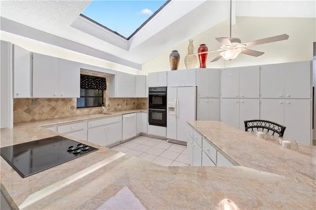 a kitchen with a sink appliances and cabinets