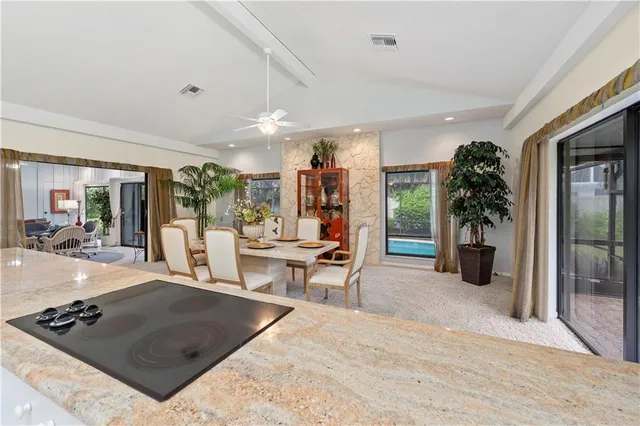 a living room with furniture and potted plants