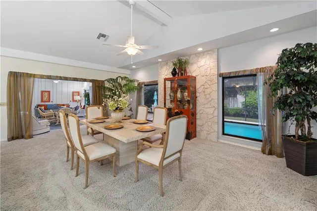 a view of a dining room with furniture and chandelier