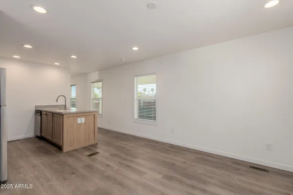 a room with a sink cabinets and wooden floor
