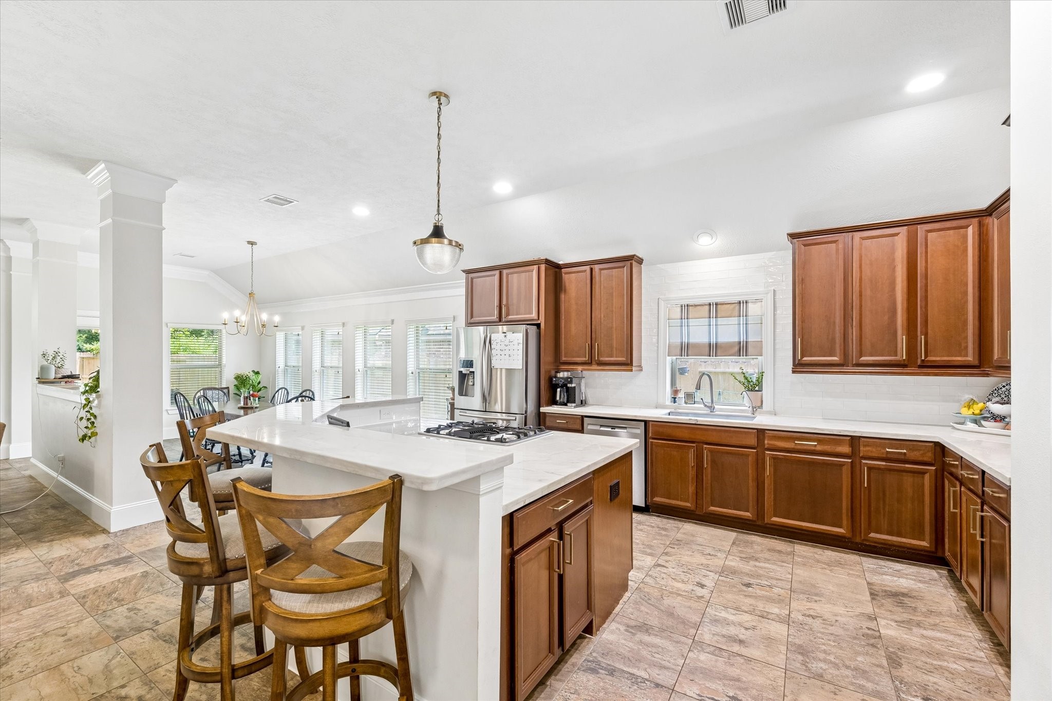 31306 Brighton Brook Lane Spring, TX 77386 - Photo 9 of 34 Beautiful kitchen with high-end quartzite countertops, stainless steel appliances, gas cooktop, and abundant storage.