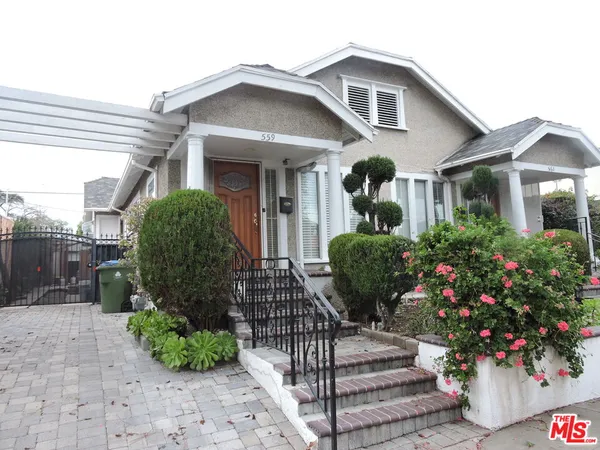 a front view of a house with a garden