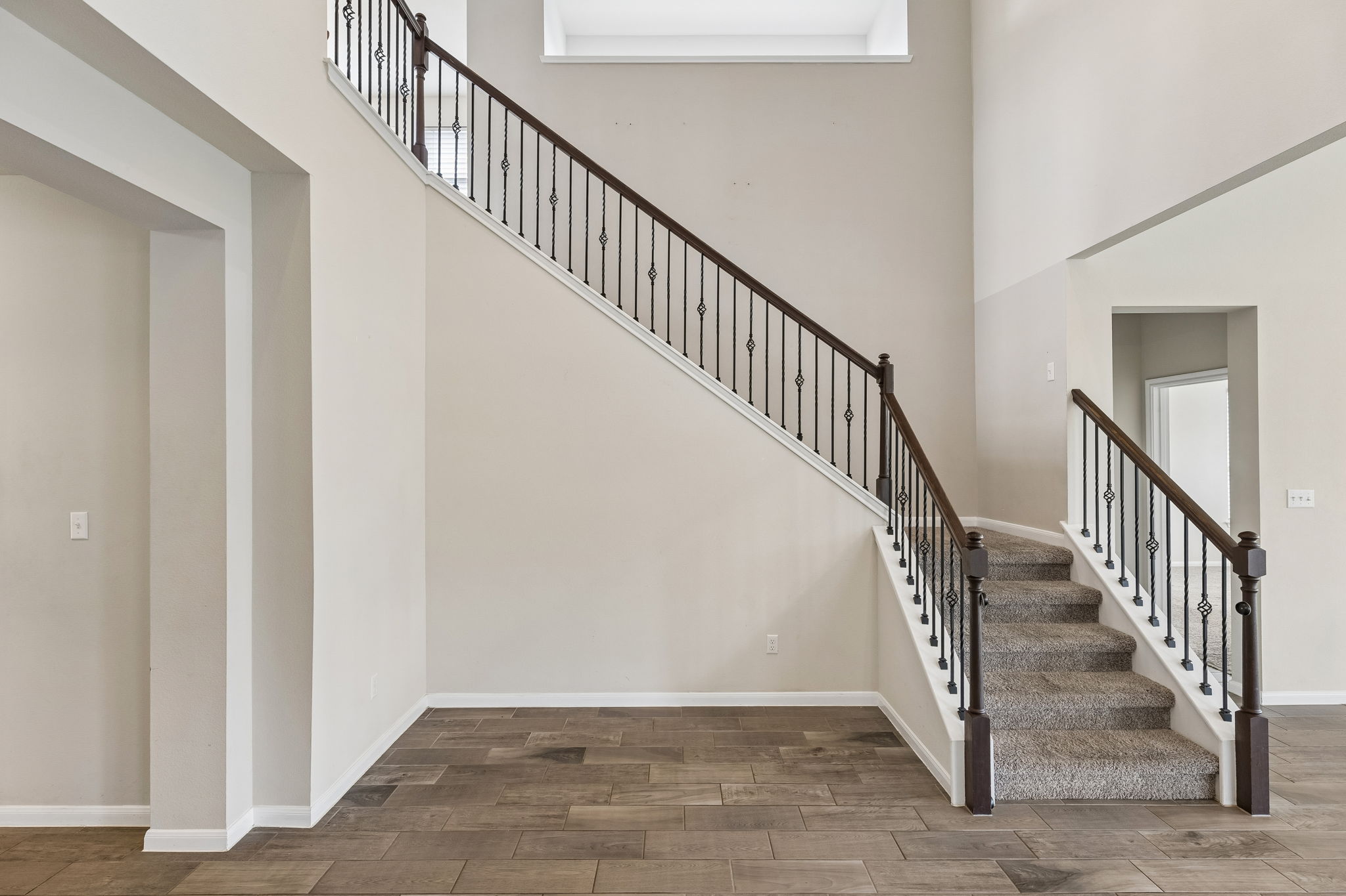 301 Rimrock Court Bastrop, TX 78602 - Photo 10 of 21 A grand double staircase with elegant wrought iron spindles defines this impressive entry.