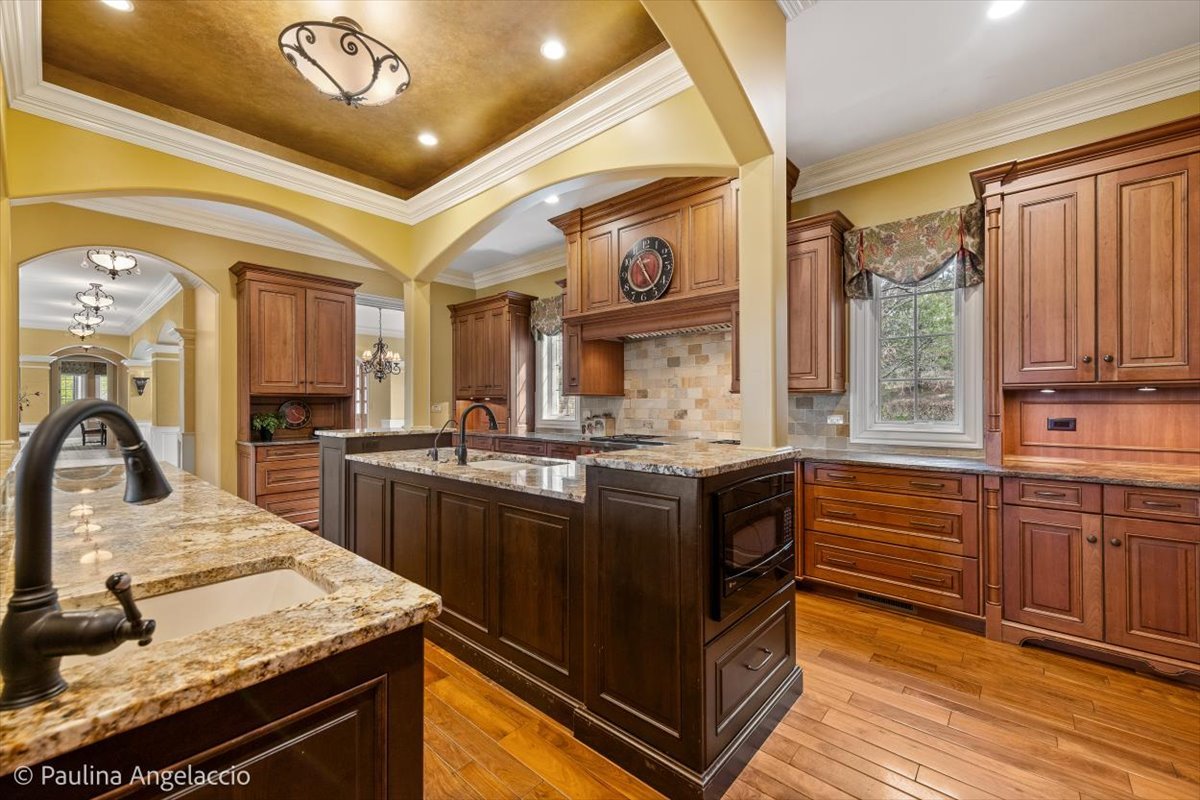 419 North Valley Hill Road Bull Valley, IL 60098 - Photo 17 of 95 a kitchen with stainless steel appliances granite countertop a sink a stove and a wooden floors