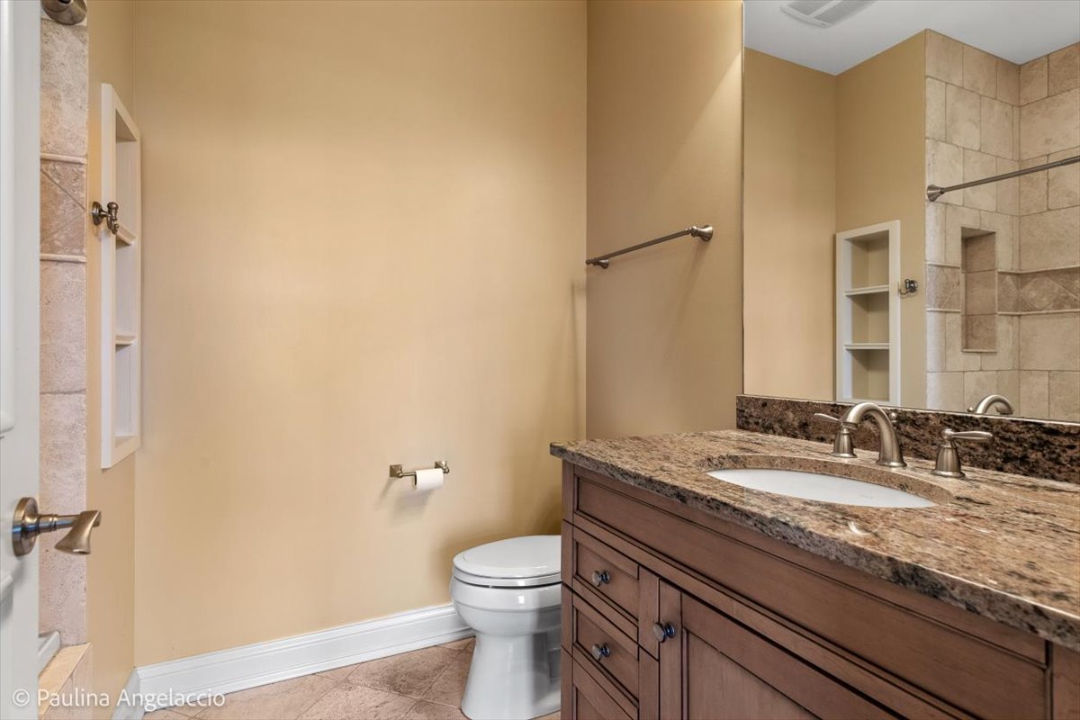 419 North Valley Hill Road Bull Valley, IL 60098 - Photo 48 of 95 a bathroom with a granite countertop sink a toilet and a mirror