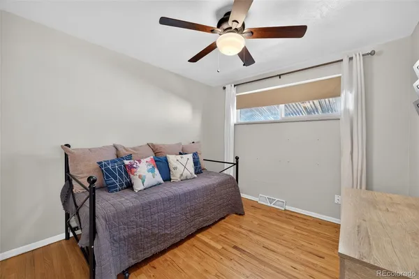 a living room with furniture and a ceiling fan