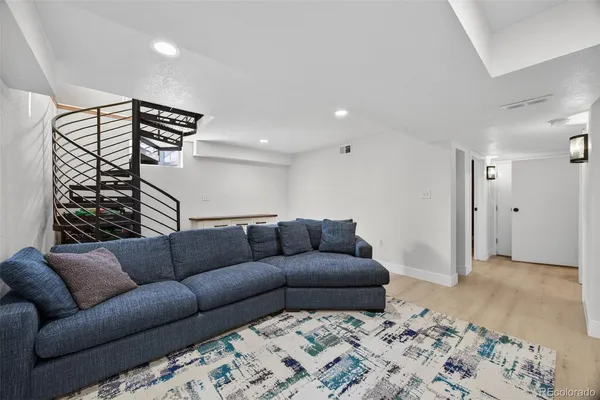 a living room with a couch and a rug