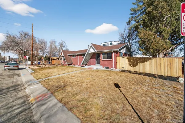 a view of a house with wooden fence