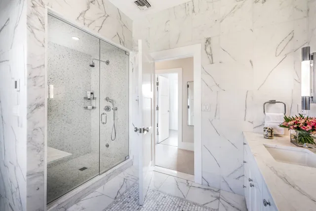 a bathroom with a shower sink and mirror