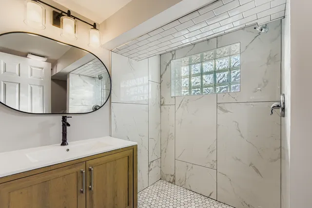 a bathroom with a sink a mirror and vanity