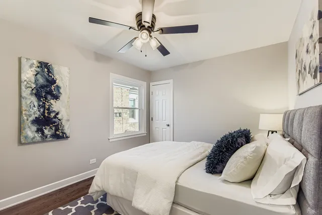 a bedroom with a large bed and a window