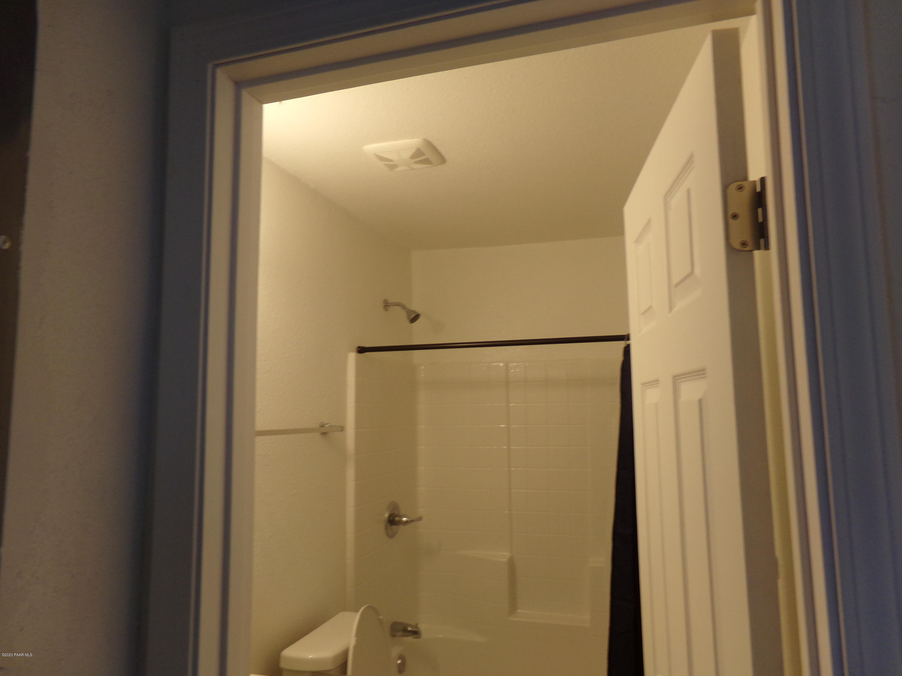 3100 Bob Court, Unit 2 Prescott Valley, AZ 86314 - Photo 9 of 10 a bathroom with a glass shower door