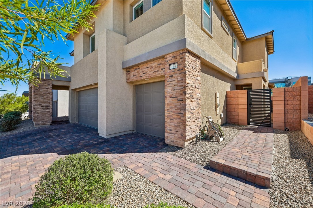 194 Viento Ridge Street Henderson, NV 89012 - Photo 4 of 72 A paved driveway and stone accents welcome you to this multi-level home.