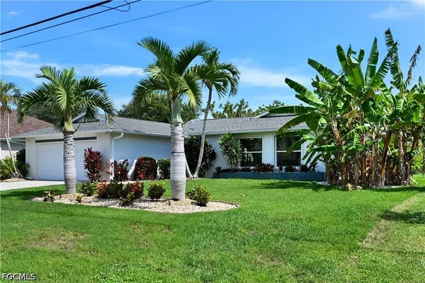 a front view of house with yard and outdoor seating