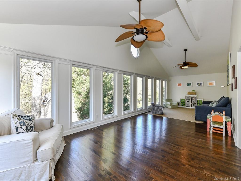 5300 Guildbrook Road Charlotte, NC 28226 - Photo 11 of 35 a view of an empty room with wooden floor and fan