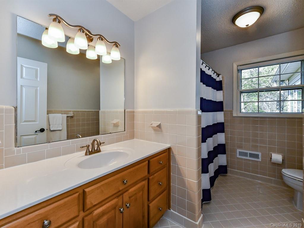 5300 Guildbrook Road Charlotte, NC 28226 - Photo 19 of 35 a bathroom with a sink a toilet and a mirror