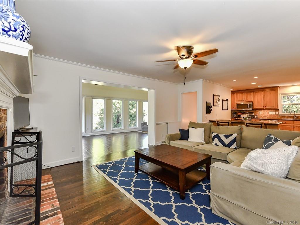 5300 Guildbrook Road Charlotte, NC 28226 - Photo 9 of 35 a living room with furniture a dining table and a fireplace