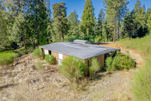 an aerial view of a house with a yard