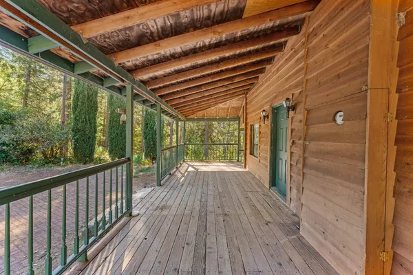 a view of porch with green trees in front