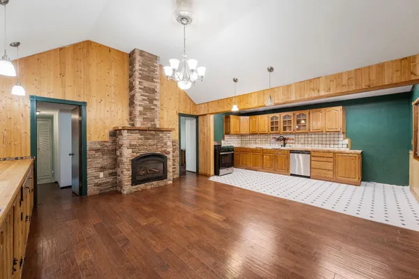 a kitchen with stainless steel appliances a stove a sink and a cabinets