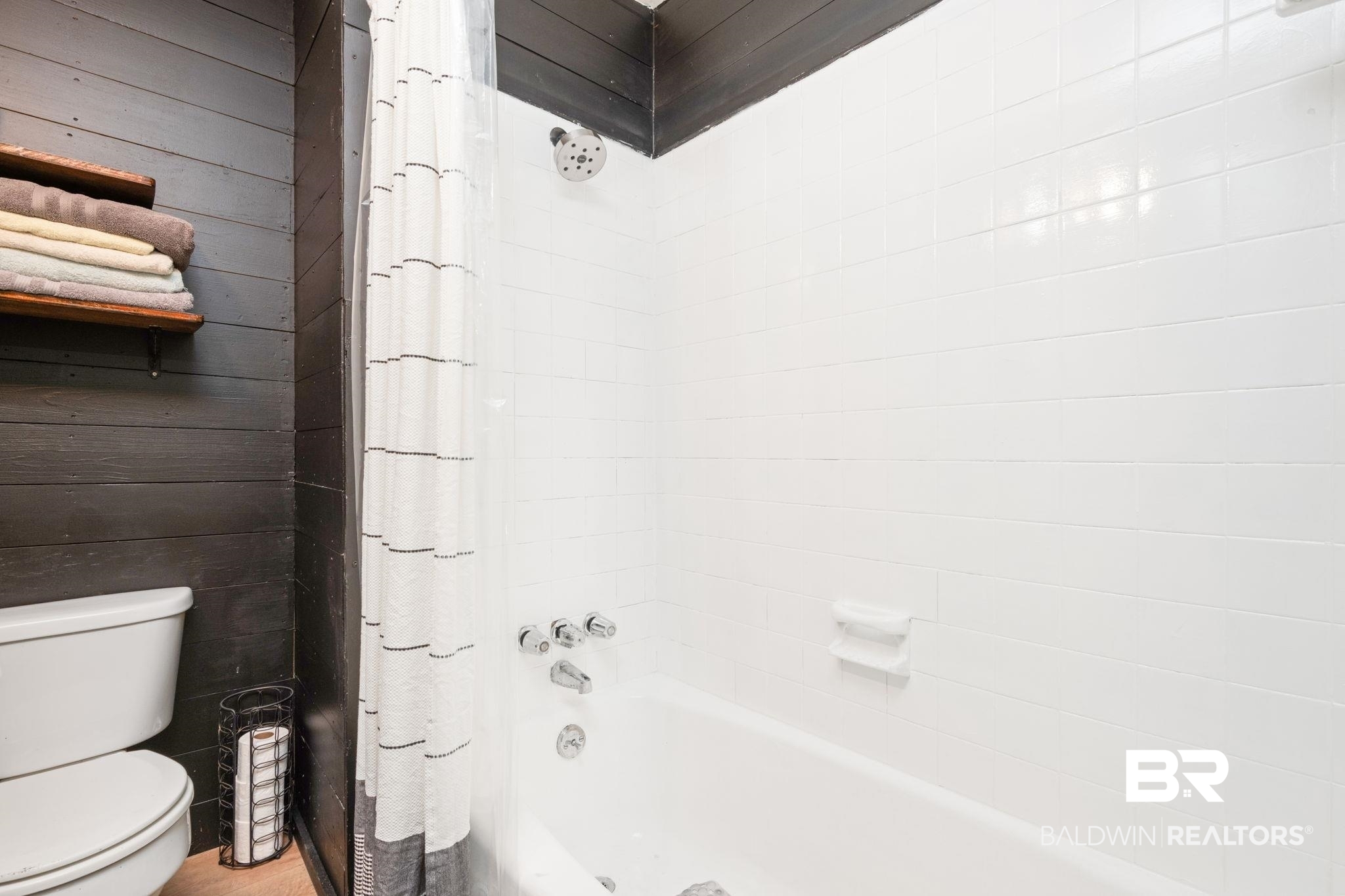 305 Alpine Street Mobile, AL 36611 - Photo 12 of 21 Bathroom with shower / bath combination with curtain, wooden walls, and toilet