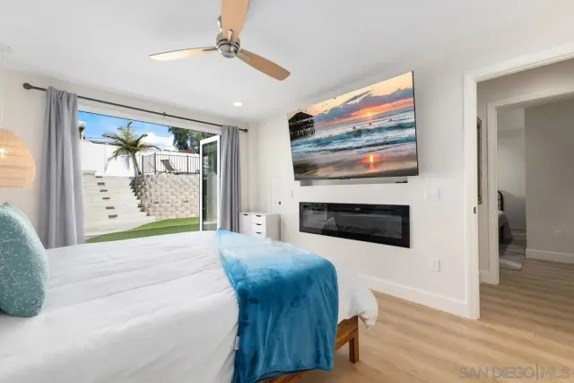 a bedroom with furniture and a fireplace