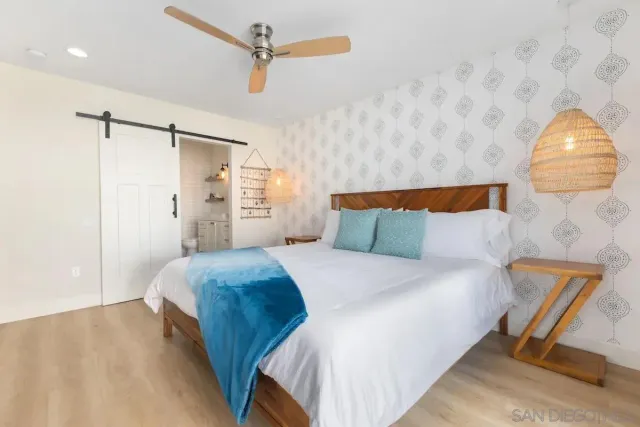 a bedroom with a bed and a mirror