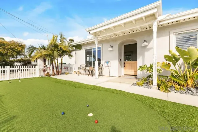 a view of a patio with table and chairs and potted plants
