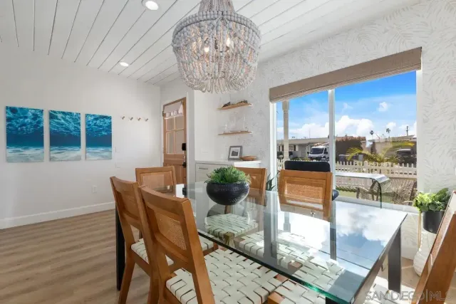 a view of a dining room with furniture wooden floor and chandelier