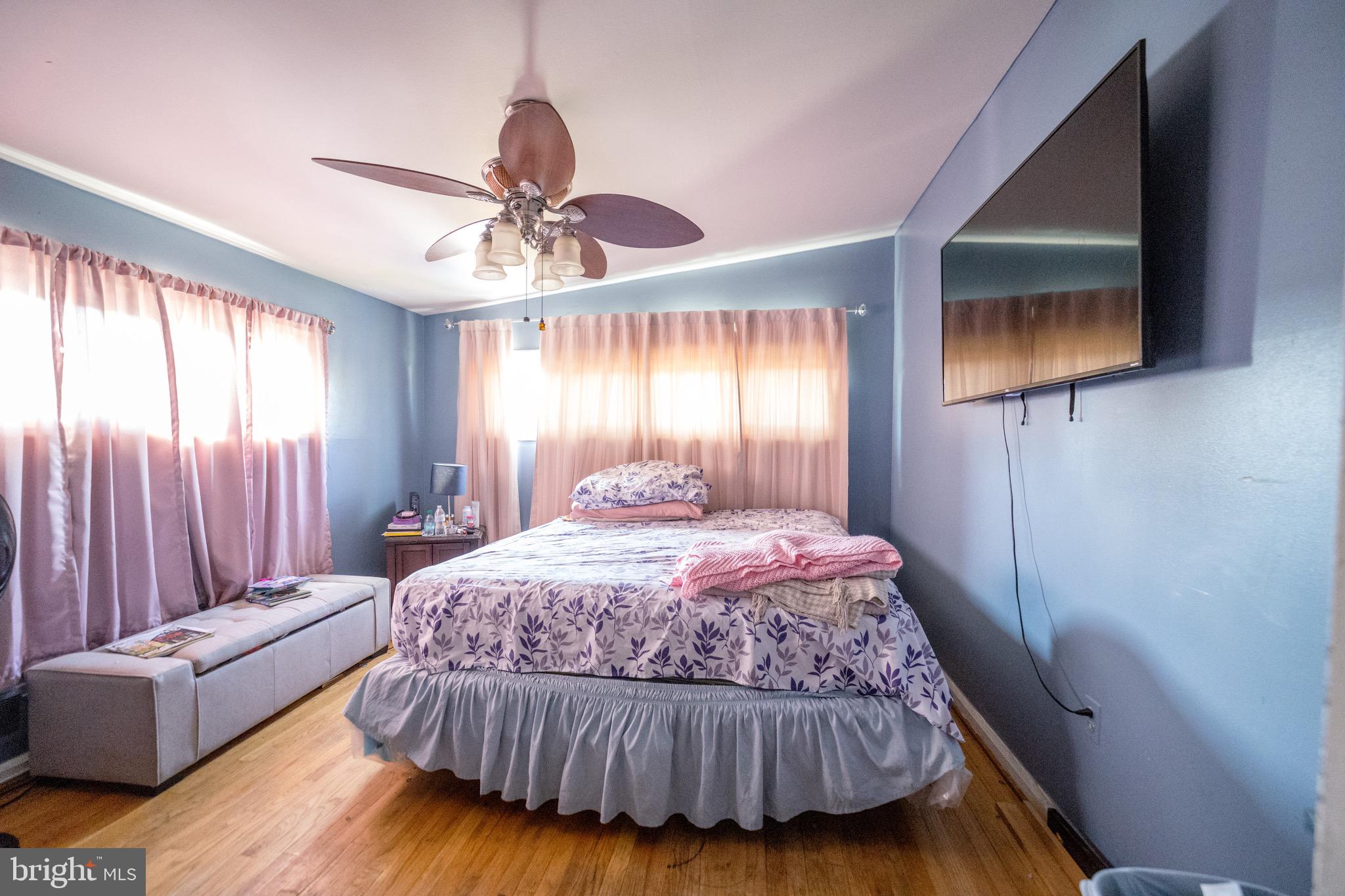 4125 Ronis Road Pikesville, MD 21208 - Photo 16 of 40 a bedroom with a bed and a chandelier