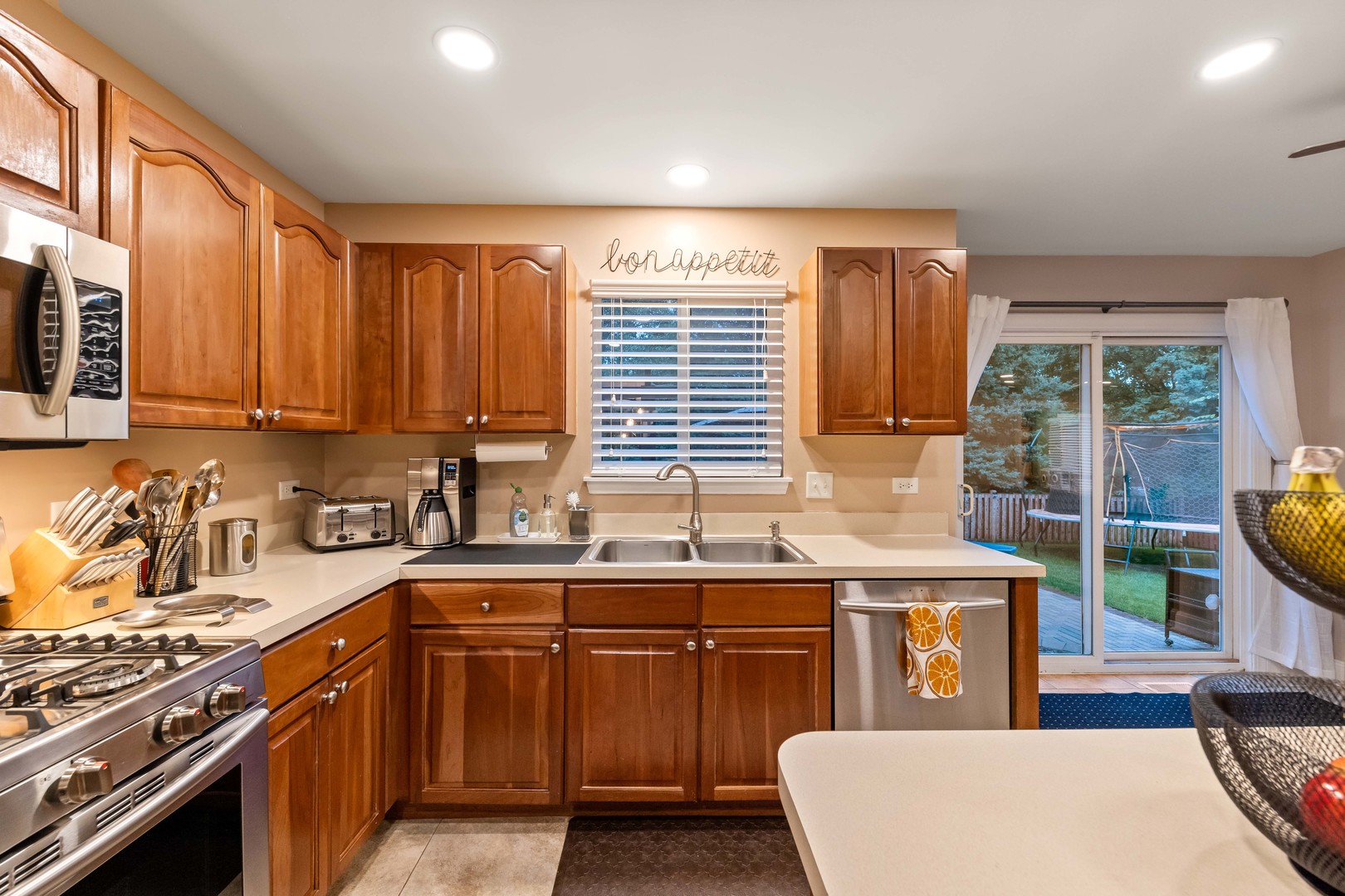 327 Berkeley Drive Bolingbrook, IL 60440 - Photo 15 of 50 a kitchen that has a sink and a stove