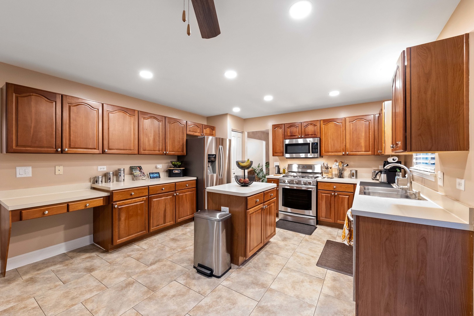 327 Berkeley Drive Bolingbrook, IL 60440 - Photo 17 of 50 a large kitchen with stainless steel appliances granite countertop a stove sink and cabinets