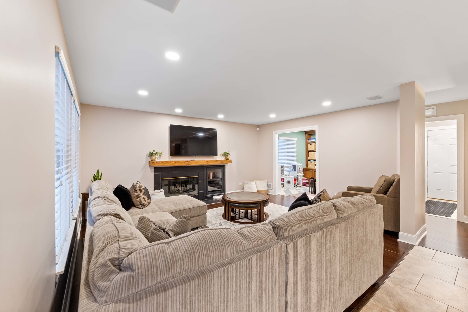 327 Berkeley Drive Bolingbrook, IL 60440 - Photo 20 of 50 a living room with furniture a fireplace and a flat screen tv