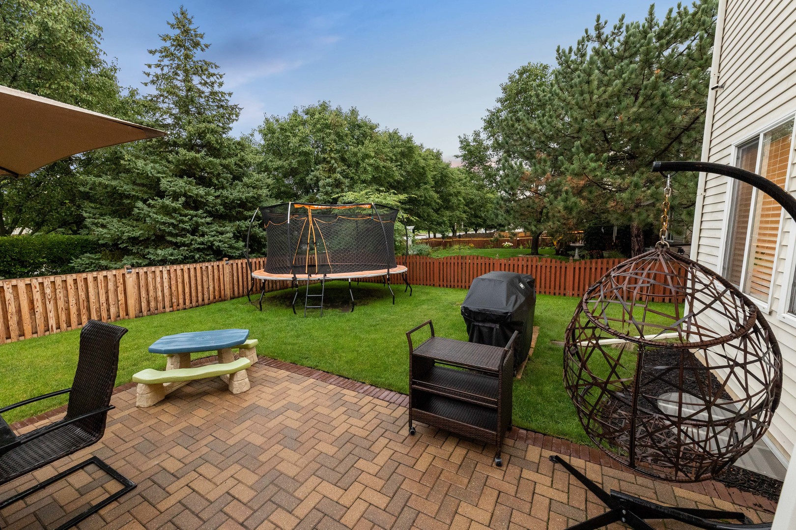 327 Berkeley Drive Bolingbrook, IL 60440 - Photo 4 of 50 a view of a chair and tables in the backyard
