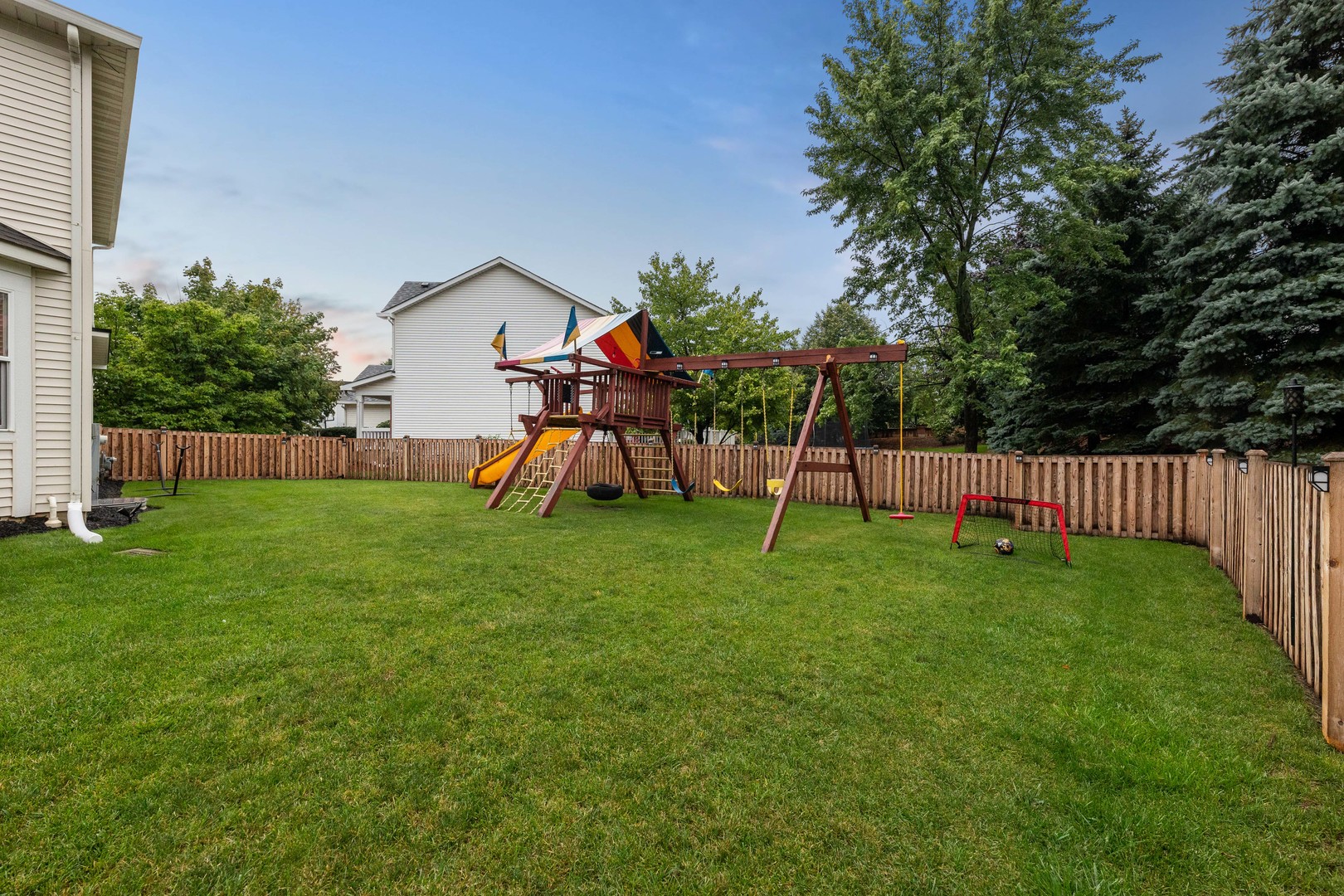 327 Berkeley Drive Bolingbrook, IL 60440 - Photo 7 of 50 a view of a house with backyard and a slide