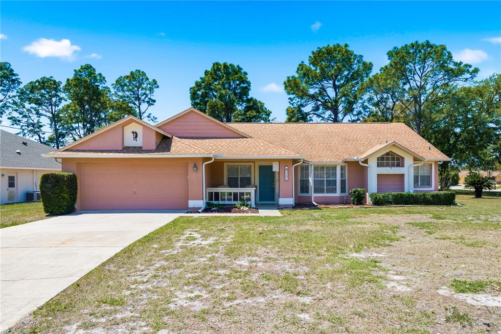 3297 Amherst Avenue Spring Hill, FL 34609 - Photo 1 of 1 a front view of a house with a yard