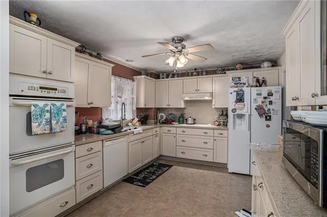 a kitchen with cabinets stainless steel appliances and a counter space