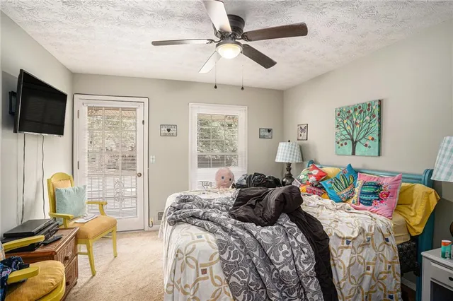 a bedroom with a bed a window and couch