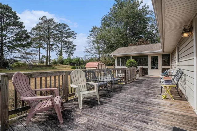 a view of a chair and table on the wooden deck