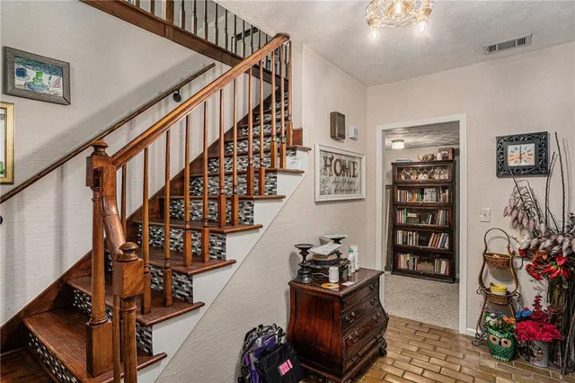 a living room with furniture and book shelf