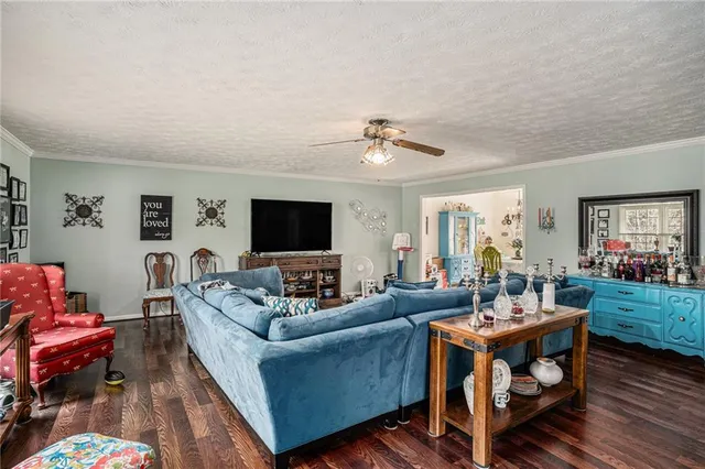 a living room with furniture a flat screen tv and a table