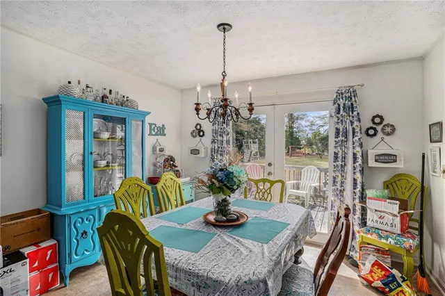 a view of a dining room with furniture and chandelier