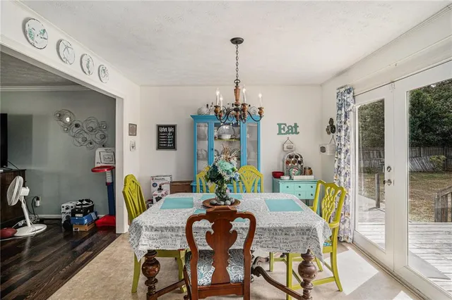 a view of a dining room with furniture and chandelier