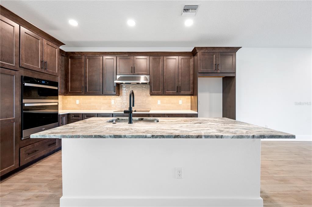 9975 Key Haven Road Seminole, FL 33777 - Photo 12 of 56 a view of a kitchen with a sink and refrigerator