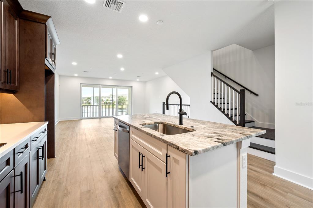 9975 Key Haven Road Seminole, FL 33777 - Photo 14 of 56 a kitchen that has a sink a stove and a wooden floor