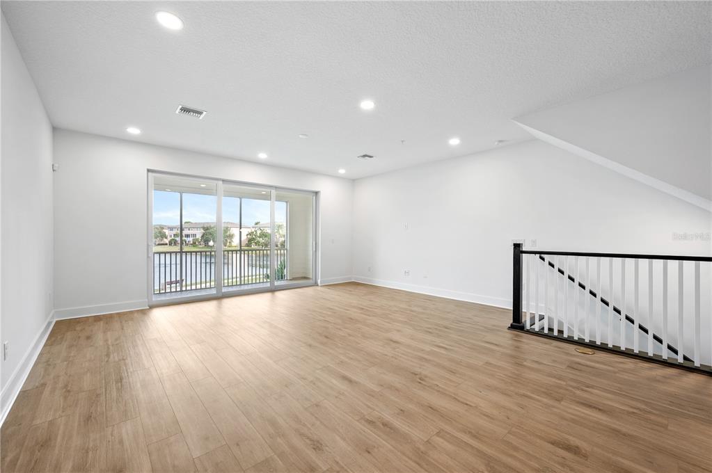 9975 Key Haven Road Seminole, FL 33777 - Photo 17 of 56 a view of an empty room with wooden floor and a window